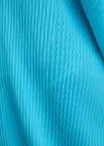 A model wears the ISSEY MIYAKE LEAF PLEATS leaf-pleats-dress-off-white.