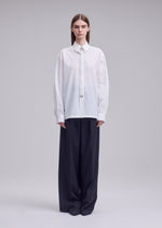 A model wears the ISSEY MIYAKE MONSIEUR SHIRT monsieur-shirt-shirt-white.