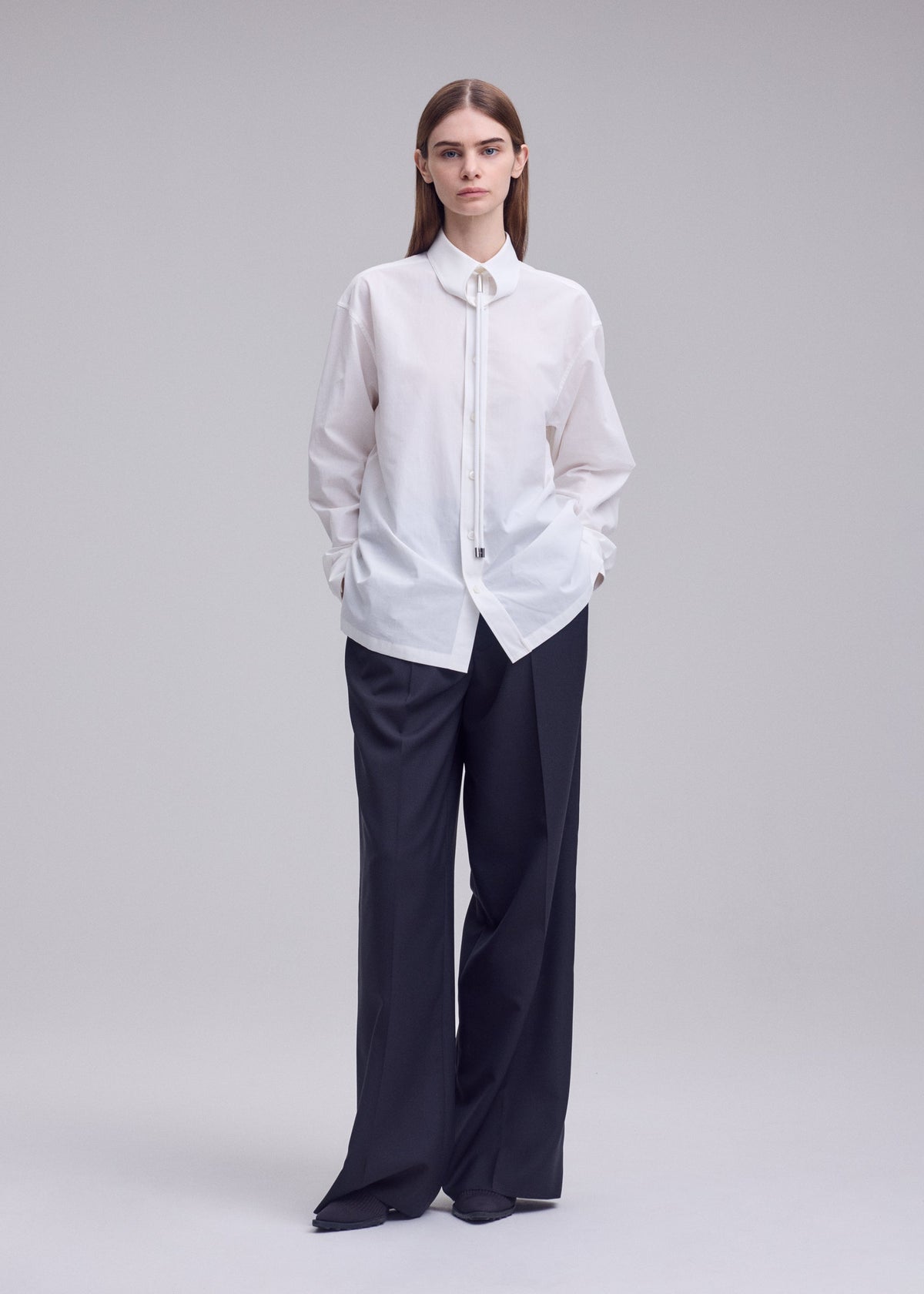 A model wears the ISSEY MIYAKE MONSIEUR SHIRT monsieur-shirt-shirt-white.