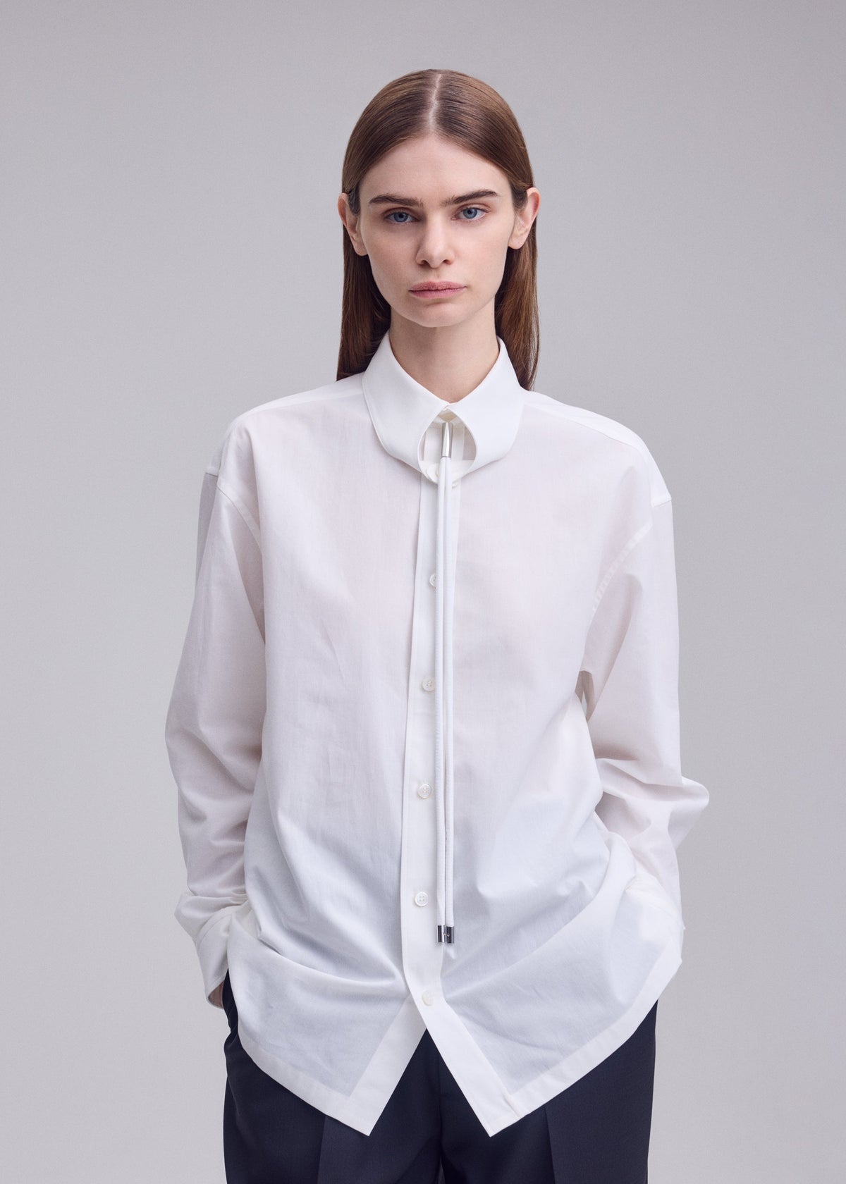 A model wears the ISSEY MIYAKE MONSIEUR SHIRT monsieur-shirt-shirt-black.
