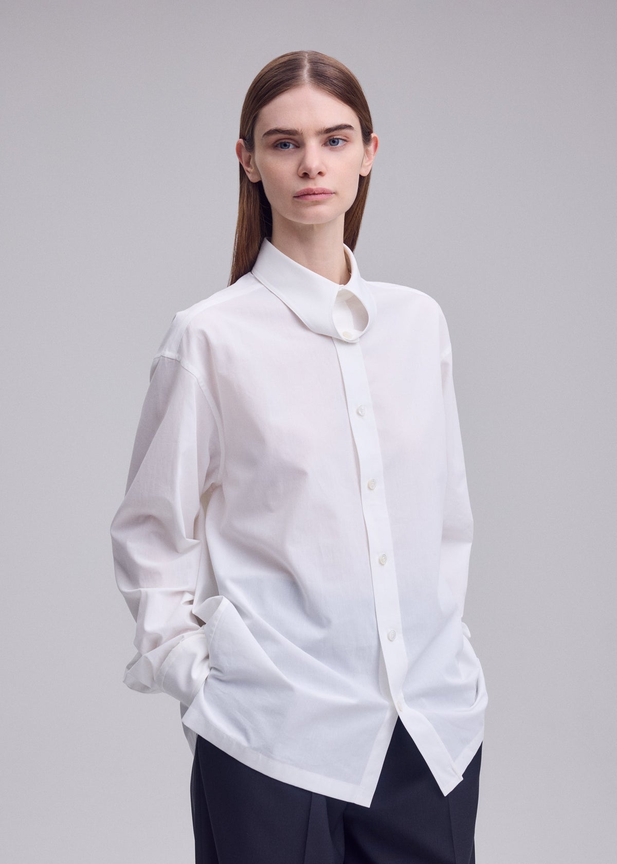 A model wears the ISSEY MIYAKE MONSIEUR SHIRT monsieur-shirt-shirt-white.