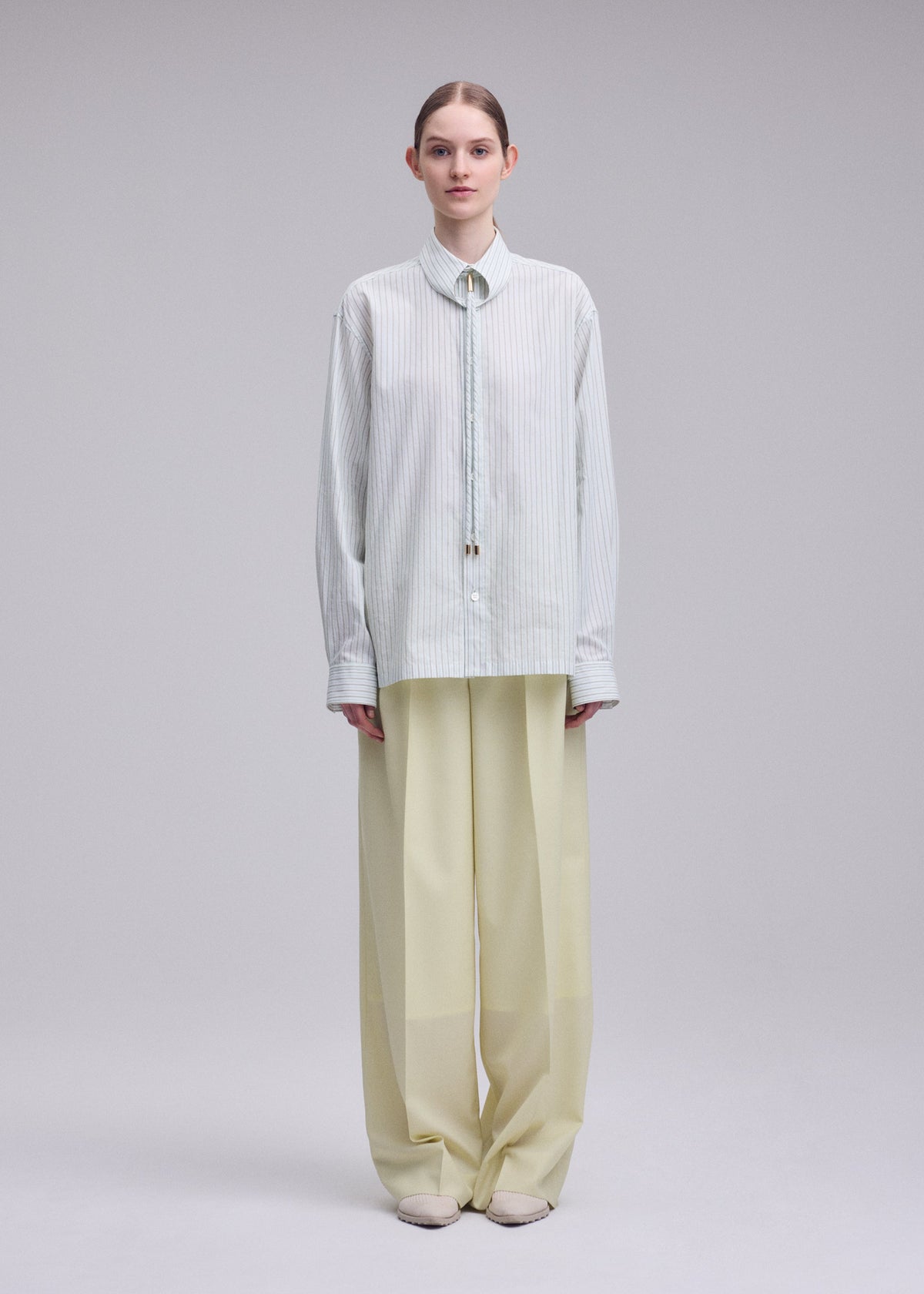 A model wears the ISSEY MIYAKE MONSIEUR SHIRT(DOBBY STRIPE) monsieur-shirt-dobby-stripe-shirt-black-hued.