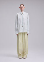 A model wears the ISSEY MIYAKE MONSIEUR SHIRT(DOBBY STRIPE) monsieur-shirt-dobby-stripe-shirt-black-hued.