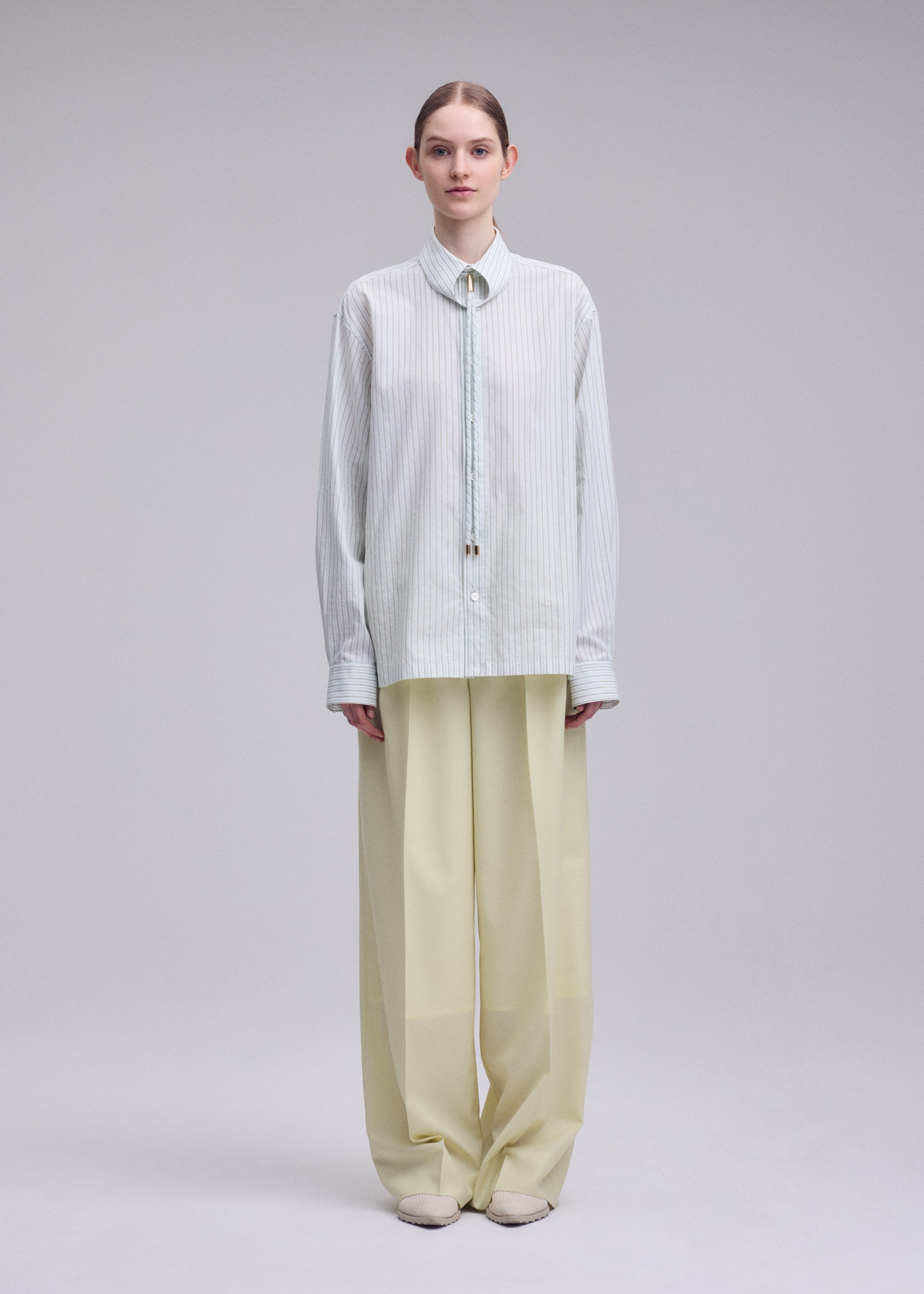 A model wears the ISSEY MIYAKE MONSIEUR SHIRT(DOBBY STRIPE) monsieur-shirt-dobby-stripe-shirt-white-hued.