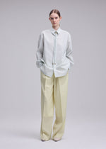 A model wears the ISSEY MIYAKE MONSIEUR SHIRT(DOBBY STRIPE) monsieur-shirt-dobby-stripe-shirt-black-hued.