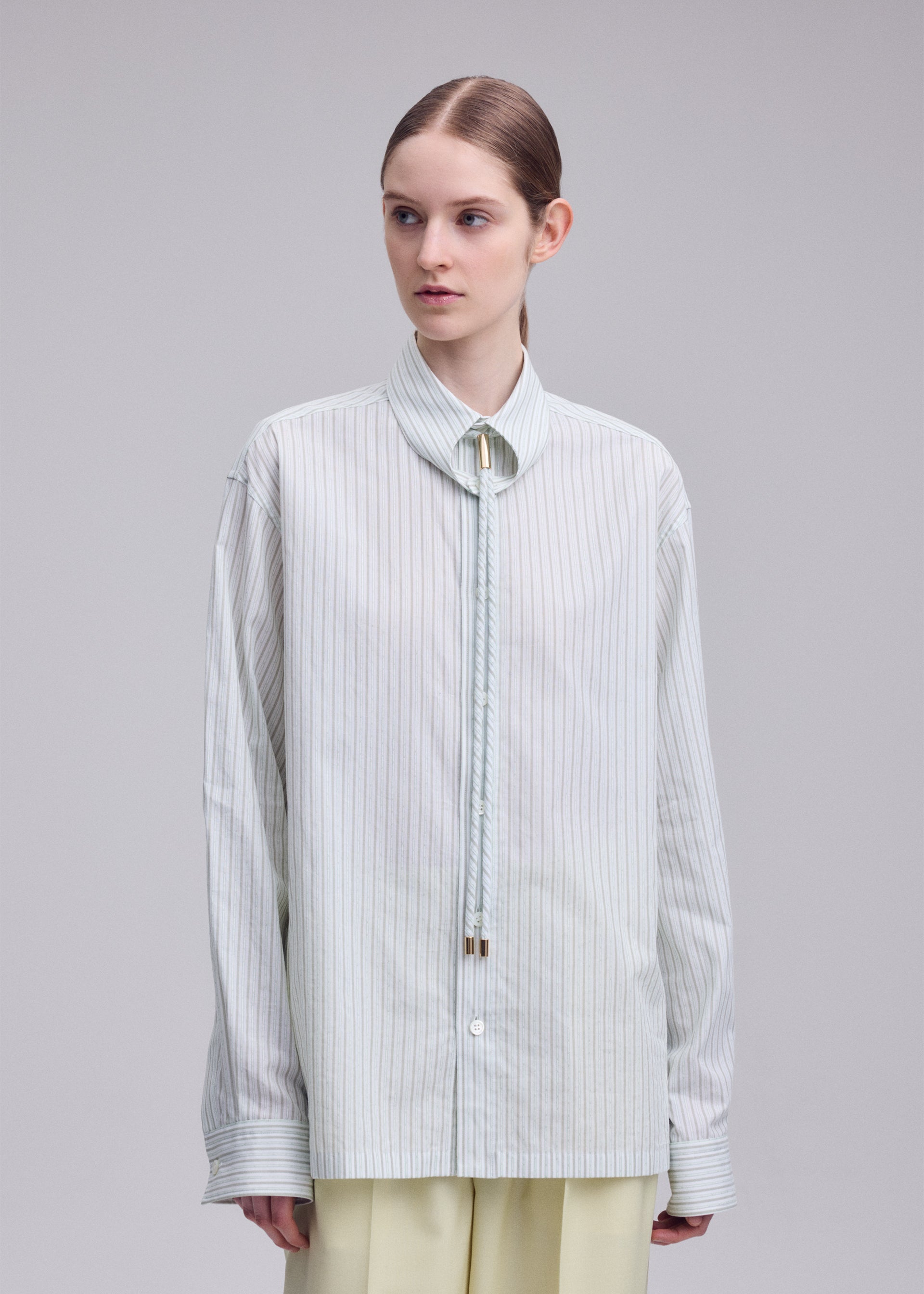 A model wears the ISSEY MIYAKE MONSIEUR SHIRT(DOBBY STRIPE) monsieur-shirt-dobby-stripe-shirt-white-hued.
