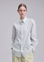A model wears the ISSEY MIYAKE MONSIEUR SHIRT(DOBBY STRIPE) monsieur-shirt-dobby-stripe-shirt-white-hued.