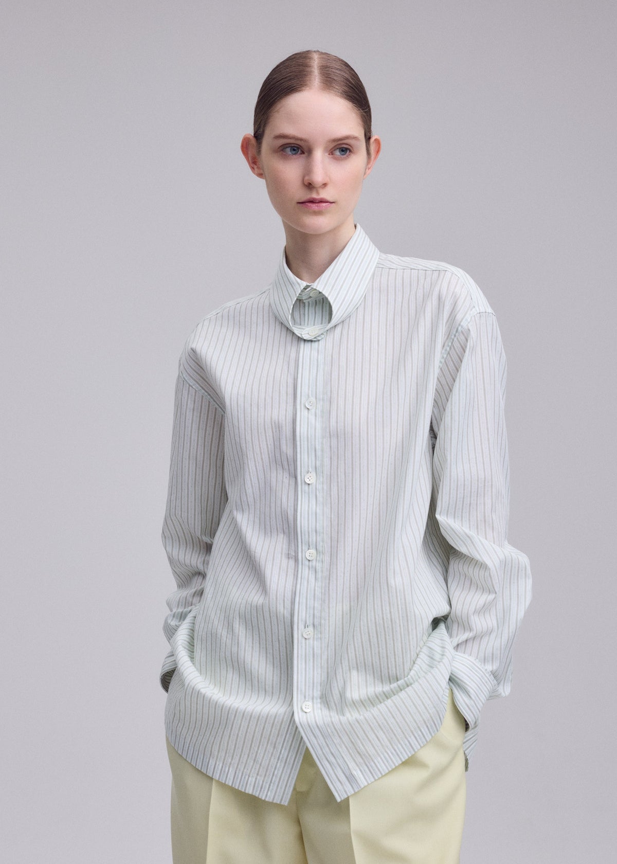 A model wears the ISSEY MIYAKE MONSIEUR SHIRT(DOBBY STRIPE) monsieur-shirt-dobby-stripe-shirt-black-hued.