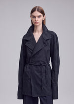 A model wears the ISSEY MIYAKE MONSIEUR SHIRT(DOBBY STRIPE) monsieur-shirt-dobby-stripe-bolo-tie-belt-shirt-black-hued.