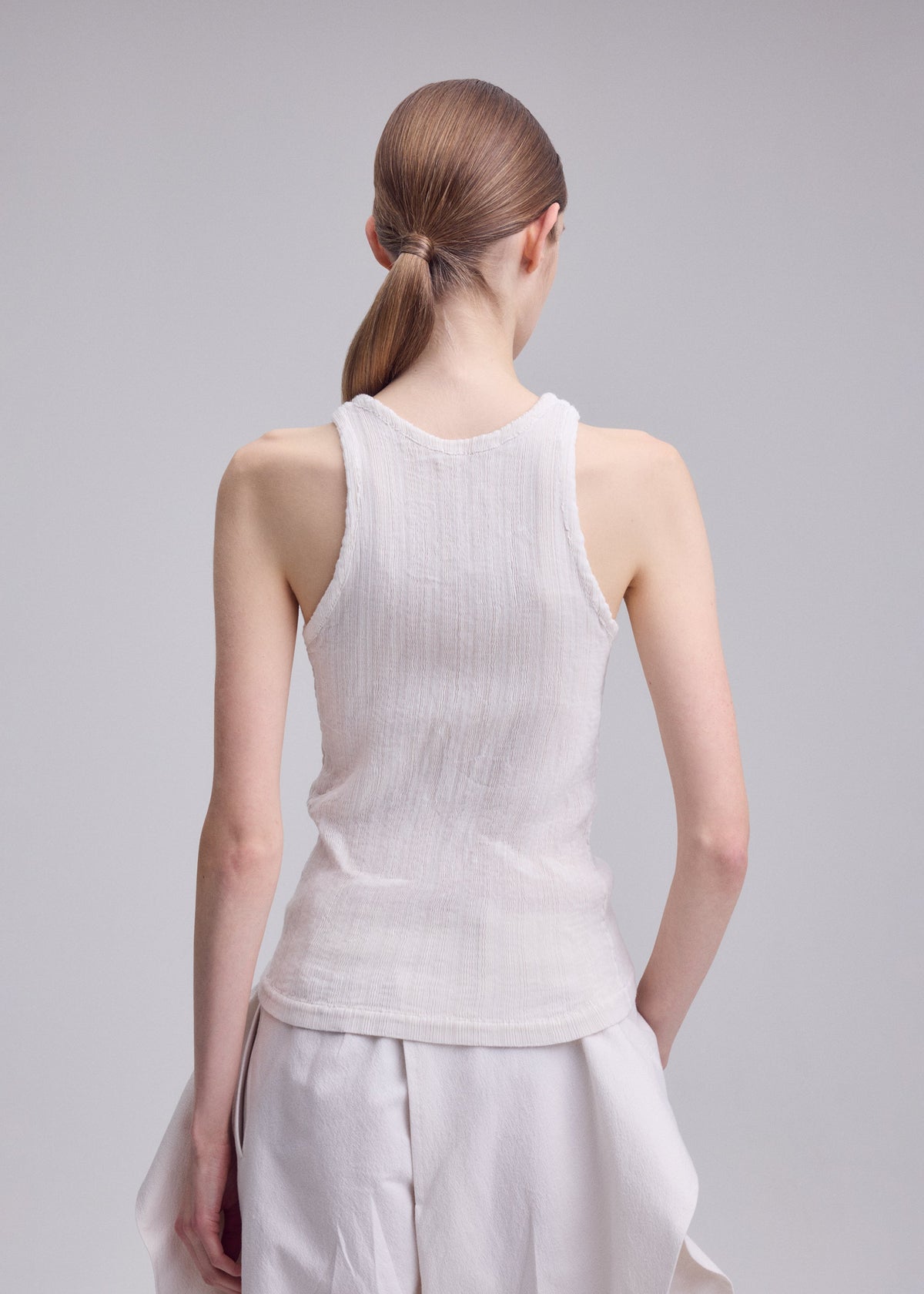 A model wears the ISSEY MIYAKE RILL rill-shirt-green.