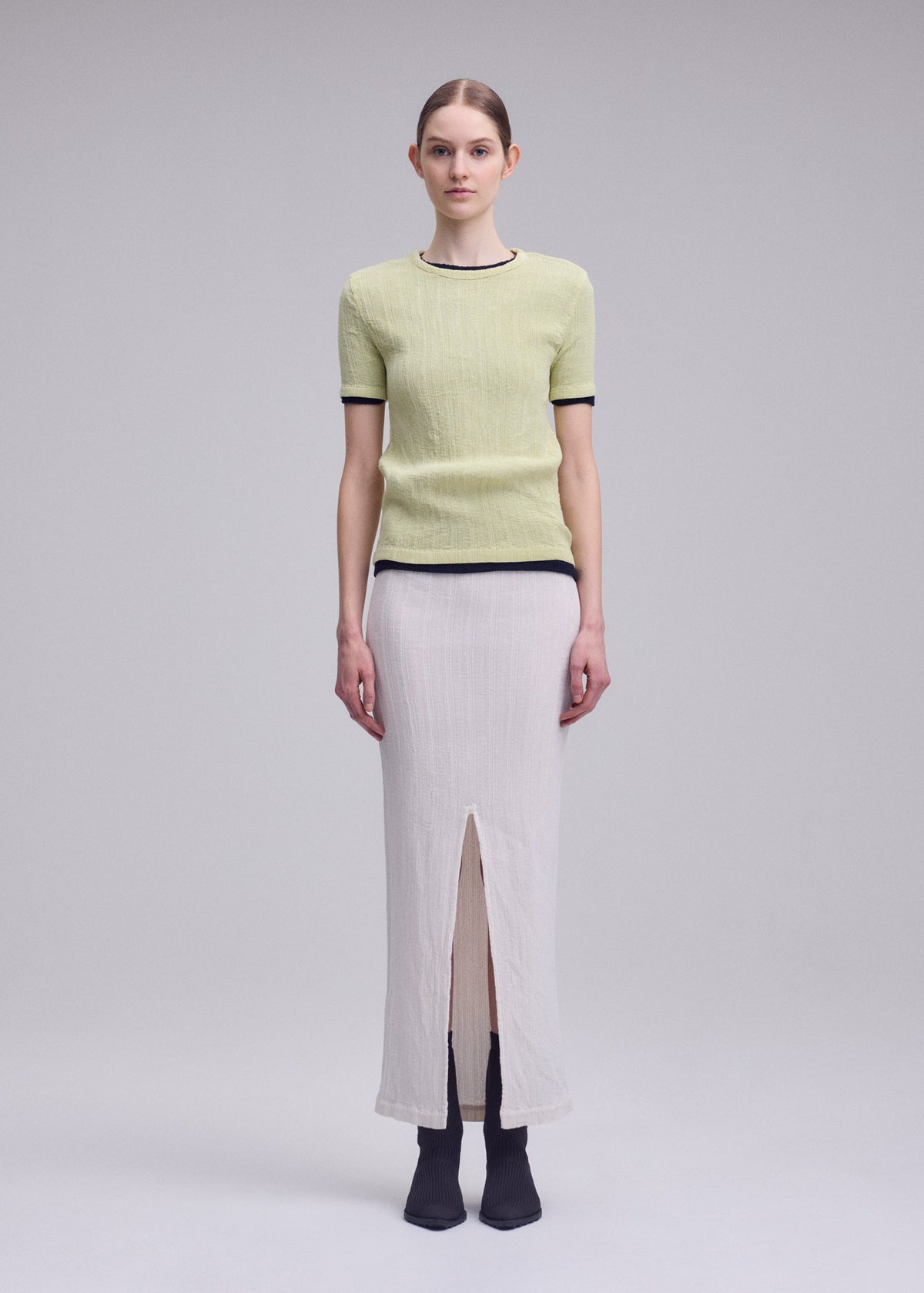 A model wears the ISSEY MIYAKE RILL rill-shirt-dull-cream-1.