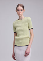 A model wears the ISSEY MIYAKE RILL rill-shirt-dull-cream-1.