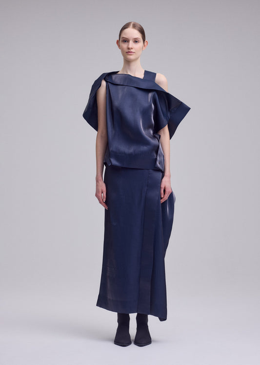 A model wears the ISSEY MIYAKE MERCURY shirt.