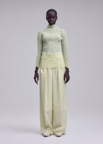 A model wears the ISSEY MIYAKE ZIGZAG PLEATS zigzag-pleats-long-sleeved-top-black.