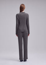 A model wears the ISSEY MIYAKE HATCHING PLEATS hatching-pleats-mock-neckline-top-black.