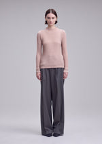 A model wears the ISSEY MIYAKE SUEDE LIKE PLEATS suede-like-pleats-long-sleeved-top-light-pink.