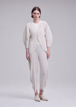 A model wears the ISSEY MIYAKE LEAF PLEATS leaf-pleats-cardigan-dark-navy.