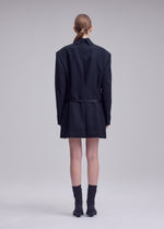 A model wears the ISSEY MIYAKE UNTITLED untitled-tunic-brown.