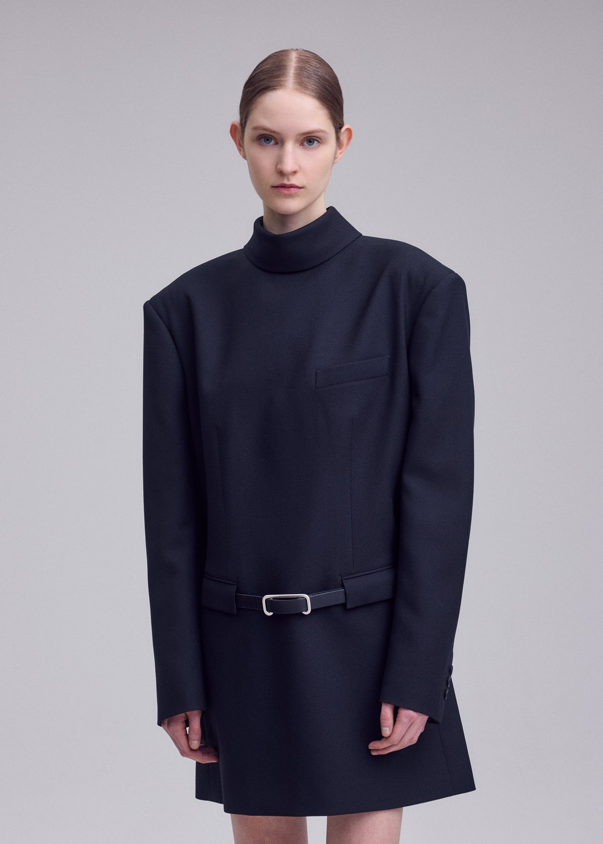 A model wears the ISSEY MIYAKE UNTITLED untitled-tunic-brown.