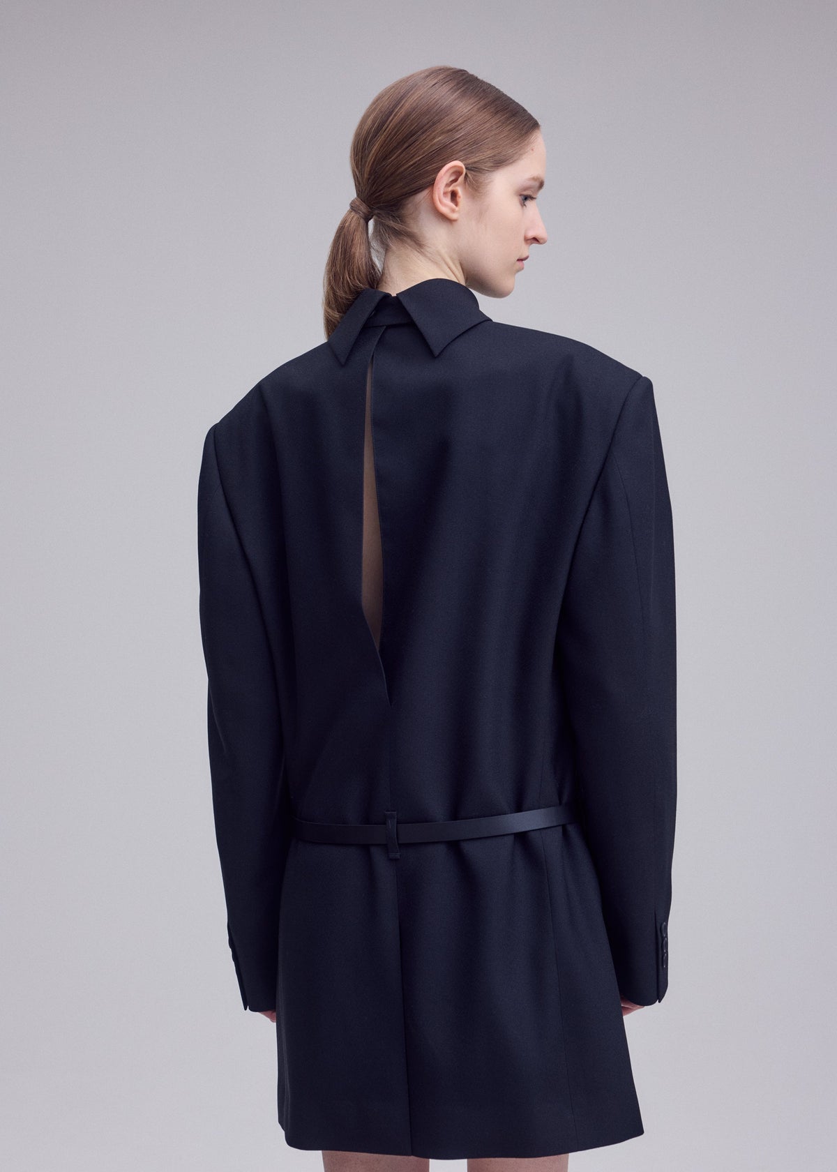 A model wears the ISSEY MIYAKE UNTITLED untitled-tunic-brown.