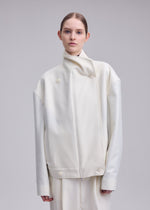 A model wears the ISSEY MIYAKE SHELL shell-jacket-grey.