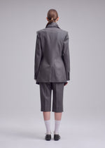 A model wears the ISSEY MIYAKE MANNER manner-jacket-black.