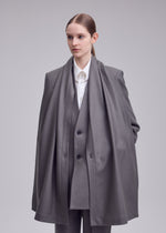 A model wears the ISSEY MIYAKE MANNER manner-jacket-grey.