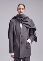 A model wears the ISSEY MIYAKE MANNER manner-jacket-grey.
