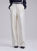 A model wears the ISSEY MIYAKE SHELL shell-trousers-grey.