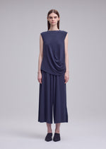 A model wears the ISSEY MIYAKE DRAPE JERSEY-68 top.