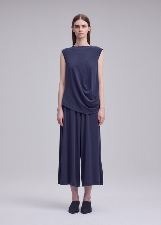A model wears the ISSEY MIYAKE DRAPE JERSEY-68 top.