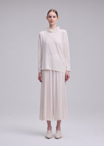 A model wears the ISSEY MIYAKE DRAPE JERSEY-68 shirt.