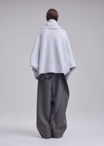 A model wears the ISSEY MIYAKE WOOLEN GRANITE woolen-granite-coat-beige.