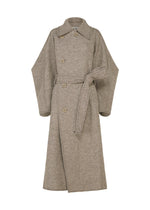 A product shot of the ISSEY MIYAKE WOOLEN GRANITE coat in beige.