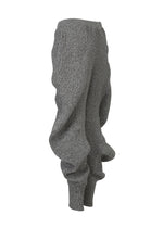 A detail shot of the ISSEY MIYAKE FOUND STONE trousers.