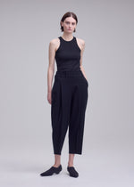 A model wears the ISSEY MIYAKE CAMPAGNE campagne-trousers-dark-navy.