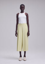 A model wears the ISSEY MIYAKE CAMPAGNE campagne-tapered-trousers-dark-navy.
