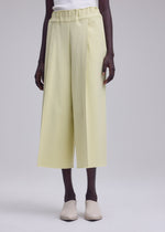 A model wears the ISSEY MIYAKE CAMPAGNE campagne-tapered-trousers-dark-navy.