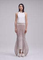 A model wears the ISSEY MIYAKE PANINI PULLED panini-pulled-skirt-black.