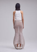 A model wears the ISSEY MIYAKE PANINI PULLED panini-pulled-skirt-black.