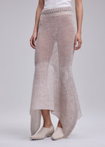 A model wears the ISSEY MIYAKE PANINI PULLED panini-pulled-skirt-light-beige.