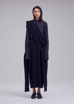 A model wears the ISSEY MIYAKE O KNIT o-knit-skirt-off-white.