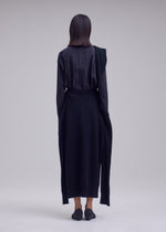 A model wears the ISSEY MIYAKE O KNIT o-knit-skirt-off-white.