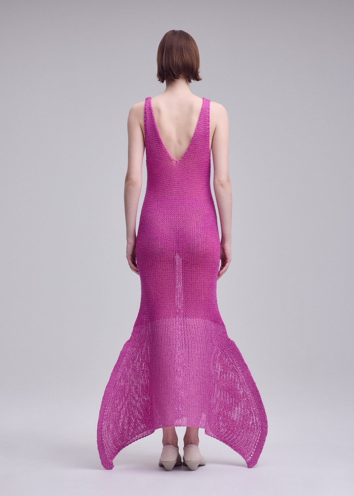 A model wears the ISSEY MIYAKE PANINI PULLED panini-pulled-dress-light-beige.