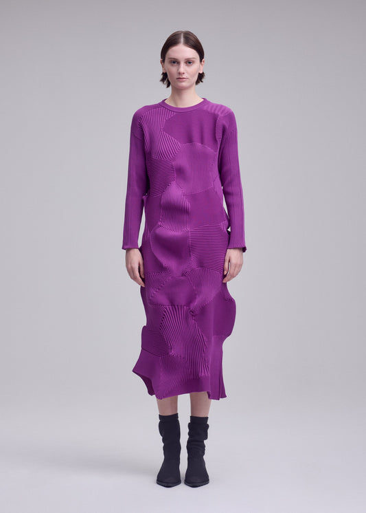 A model wears the ISSEY MIYAKE KONE KONE kone-kone-dress-purple.