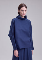 A model wears the ISSEY MIYAKE CAMPAGNE campagne-top-dark-navy.