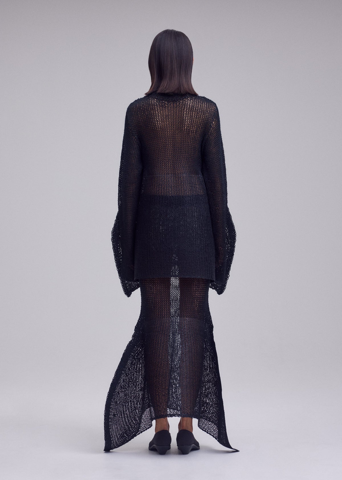 A model wears the ISSEY MIYAKE PANINI PULLED panini-pulled-top-light-beige.
