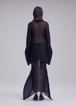 A model wears the ISSEY MIYAKE PANINI PULLED panini-pulled-top-light-beige.