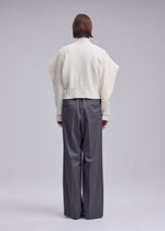 A model wears the ISSEY MIYAKE O KNIT o-knit-top-purple.