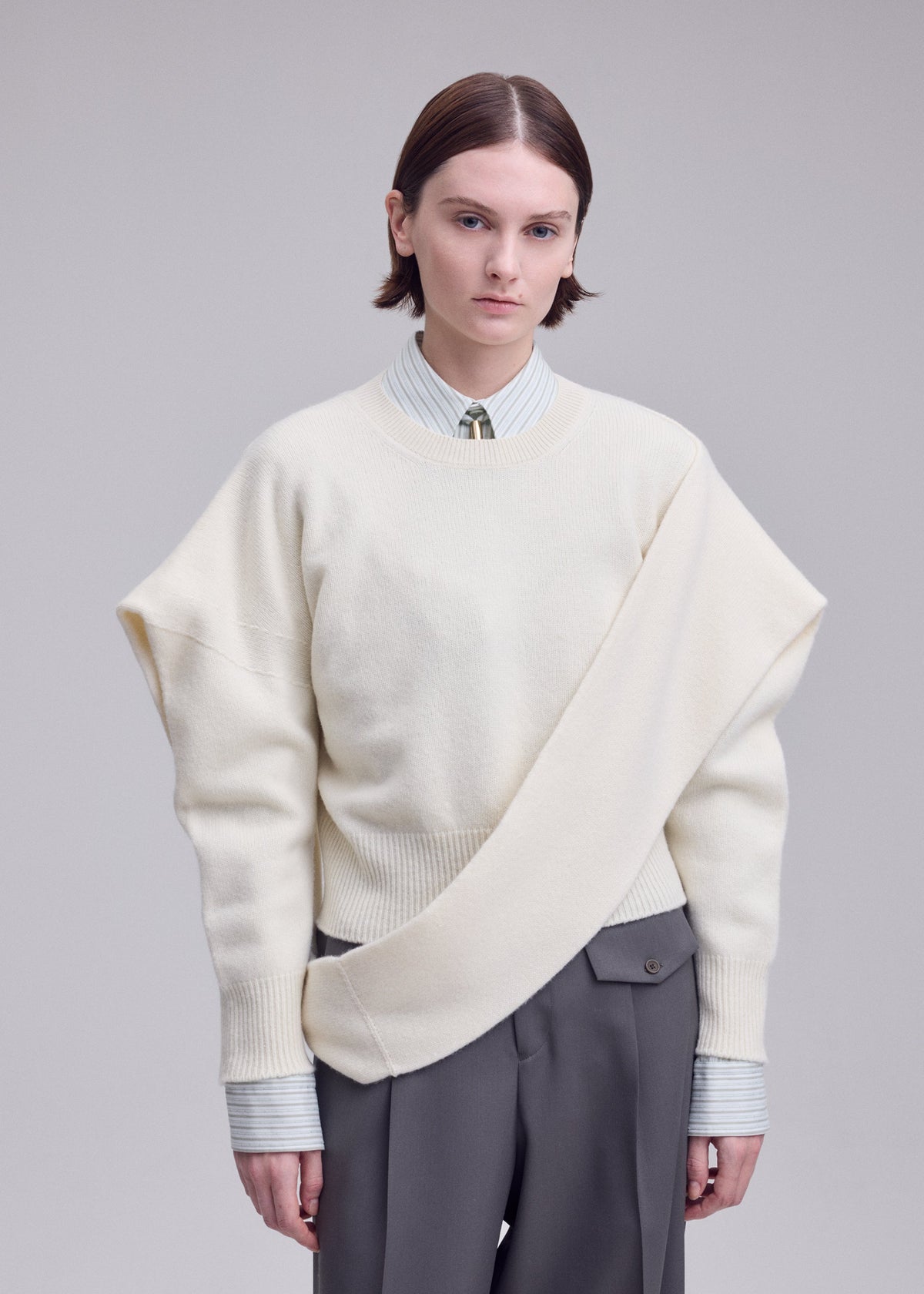 A model wears the ISSEY MIYAKE O KNIT o-knit-top-off-white.